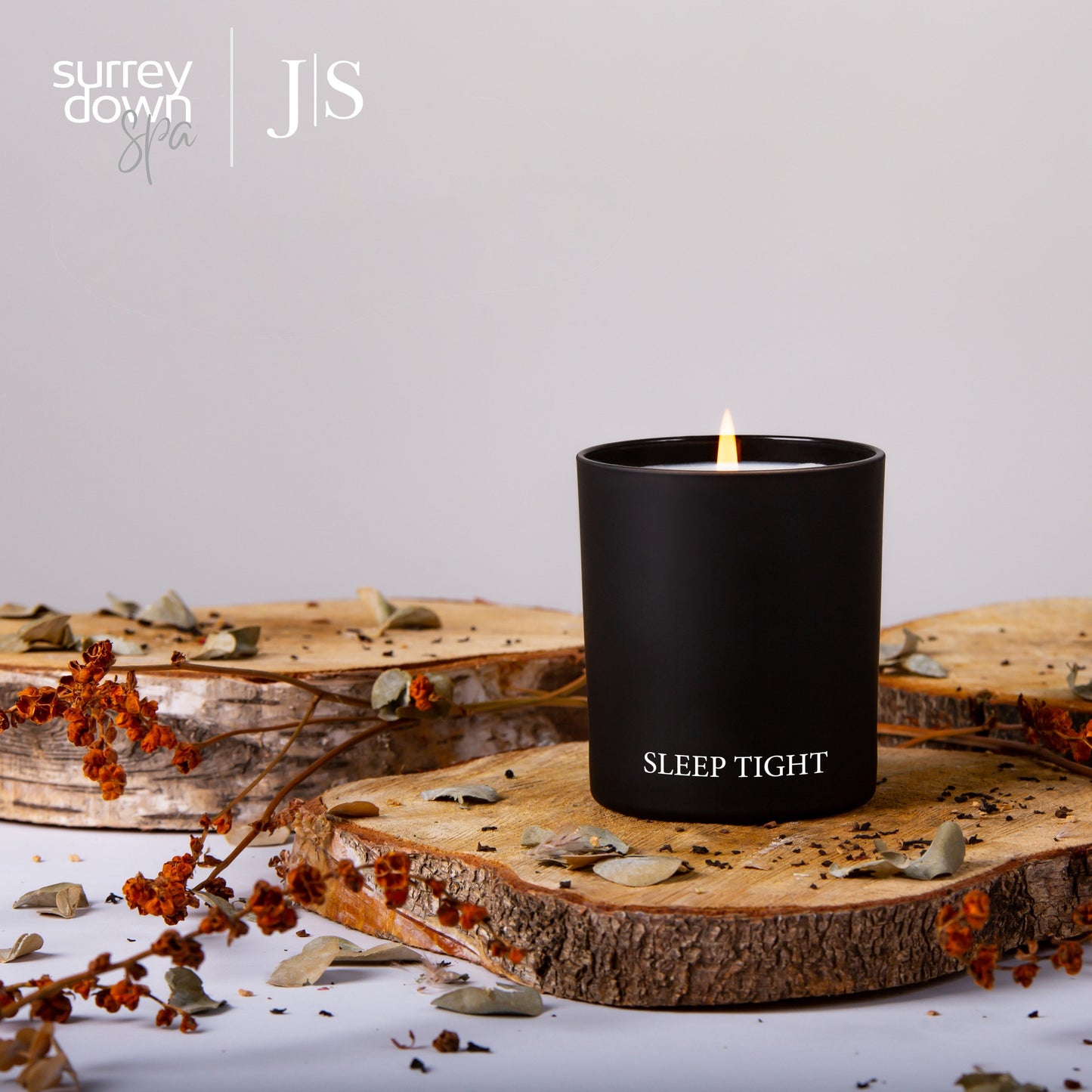 sleep tight candle on a wooden log