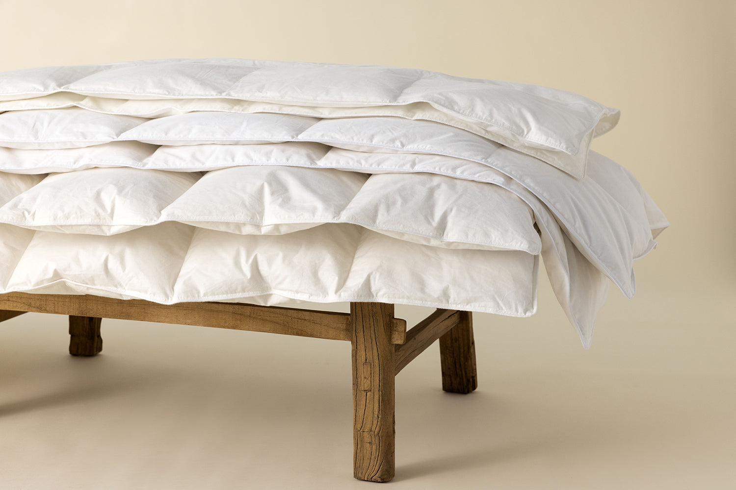 natural duvet laying on a wooden bench